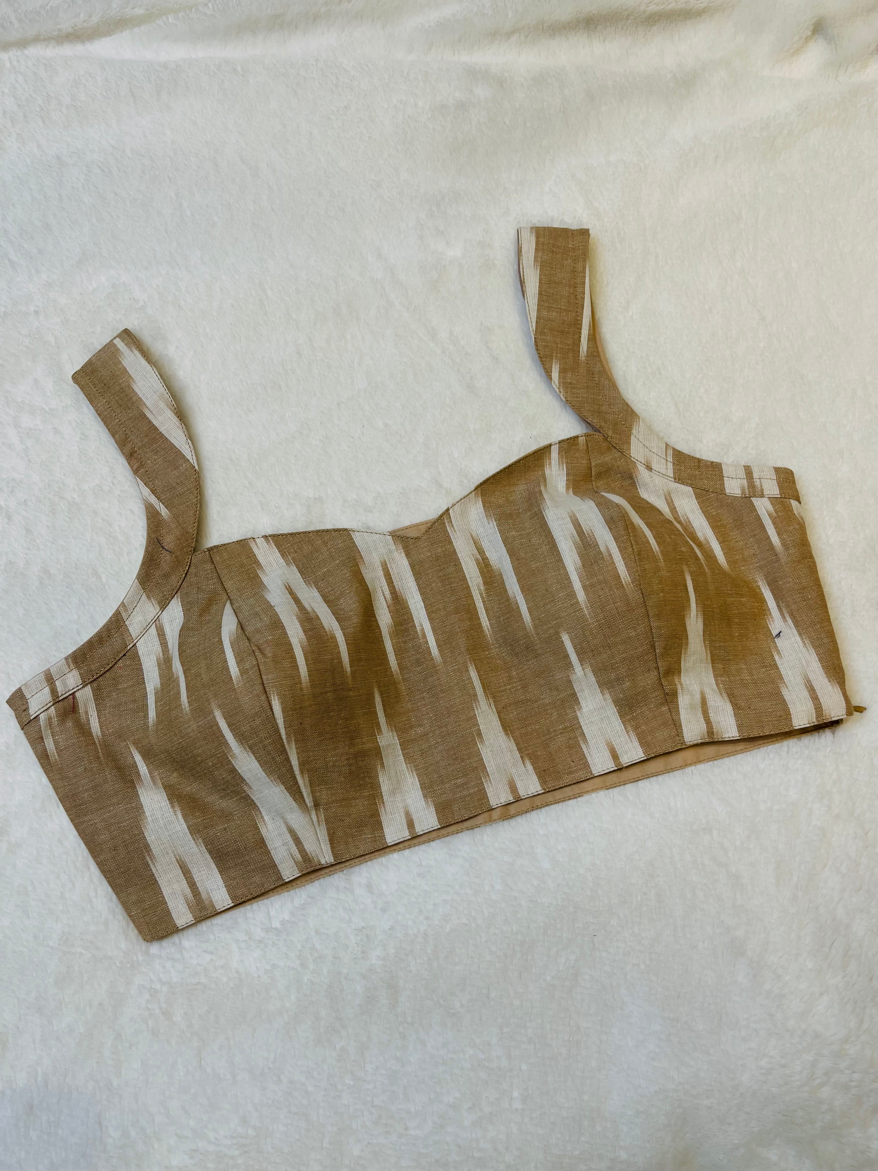 Brown and beige cotton Ikkat work sleeveless blouse with padded cups and boat neck design