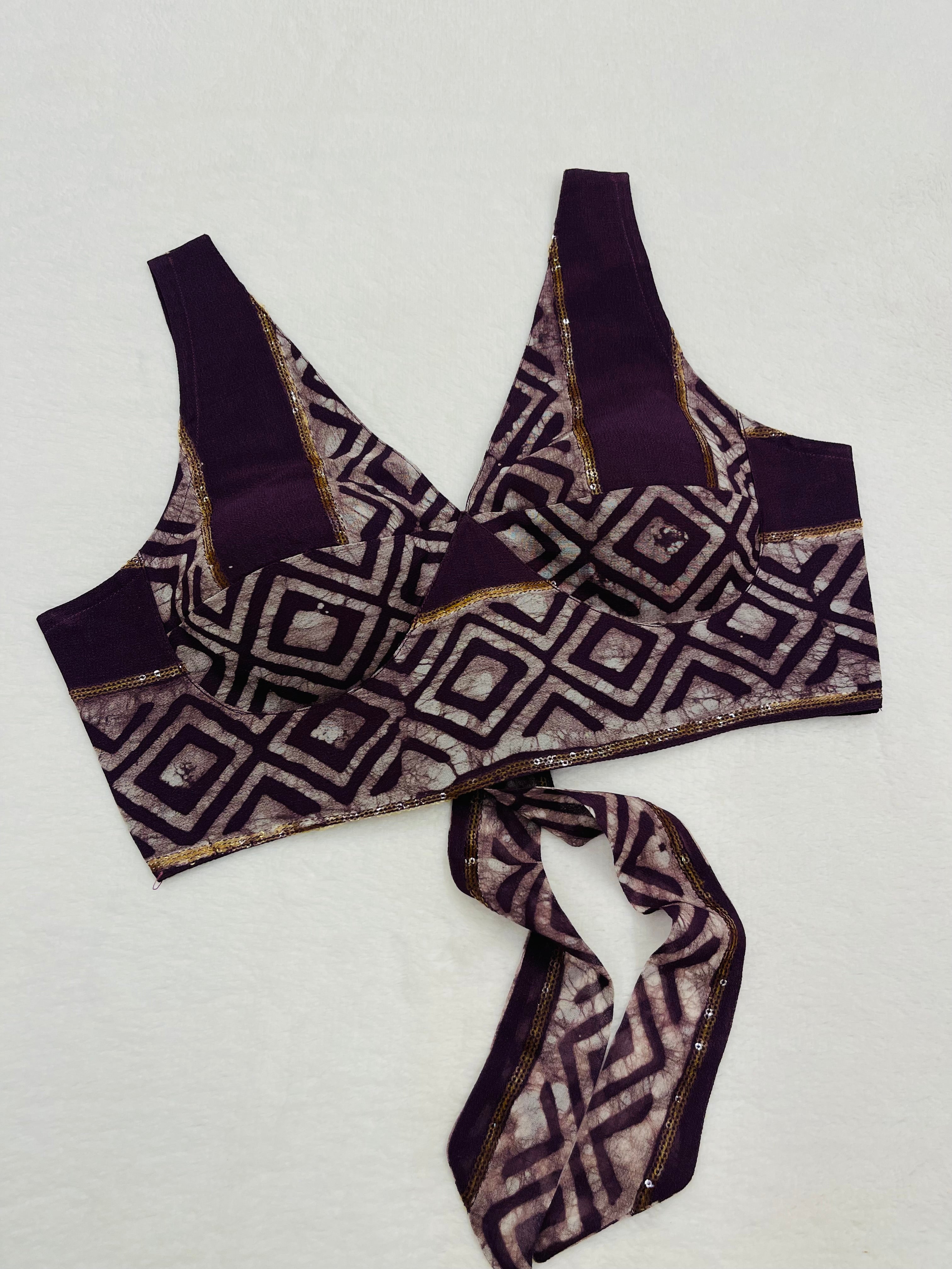Dark purple viscose georgette sleeveless printed blouse with padded cups and V-neck design