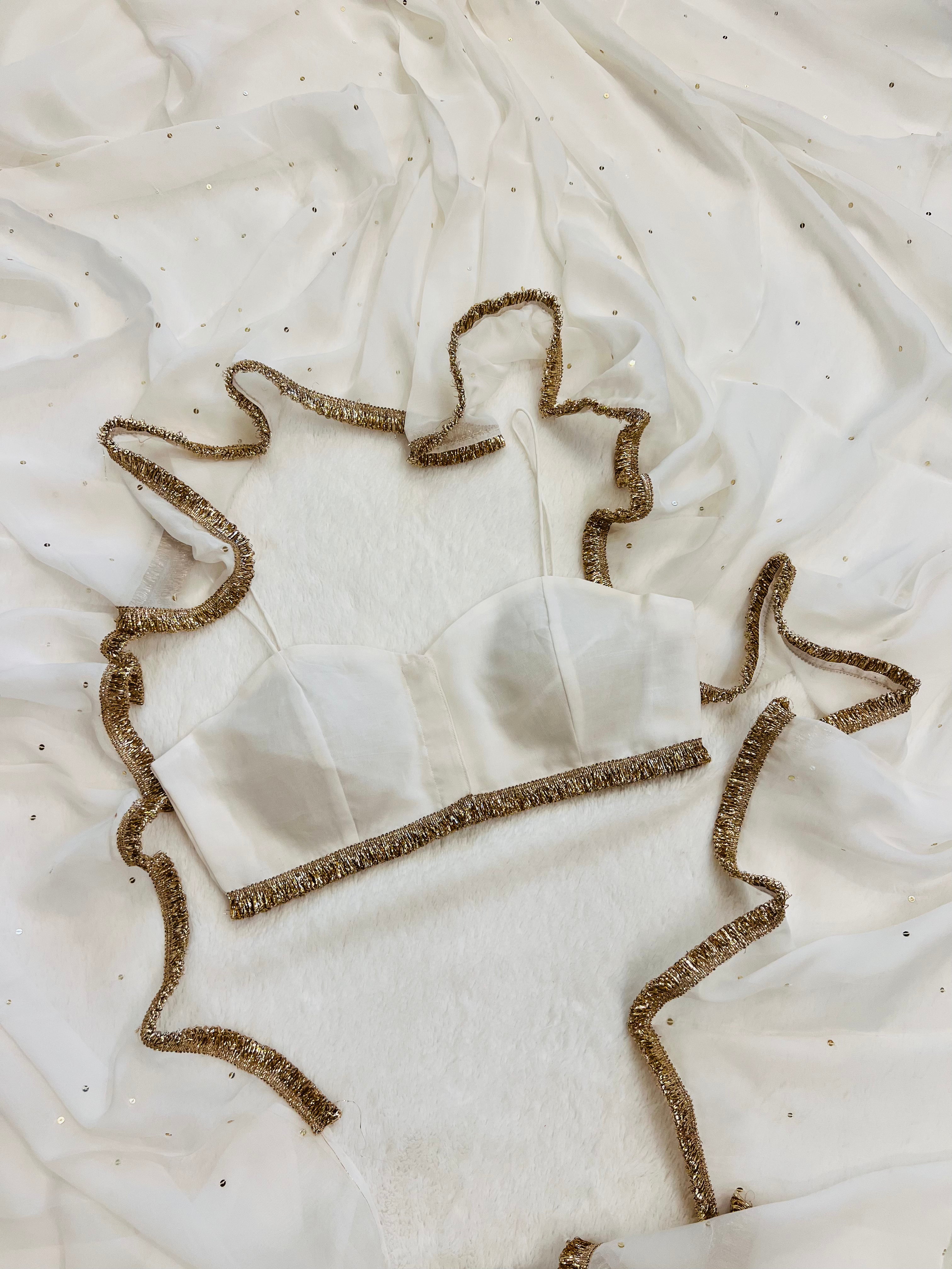 “White saree with floral hand embroidery by Sazrika”