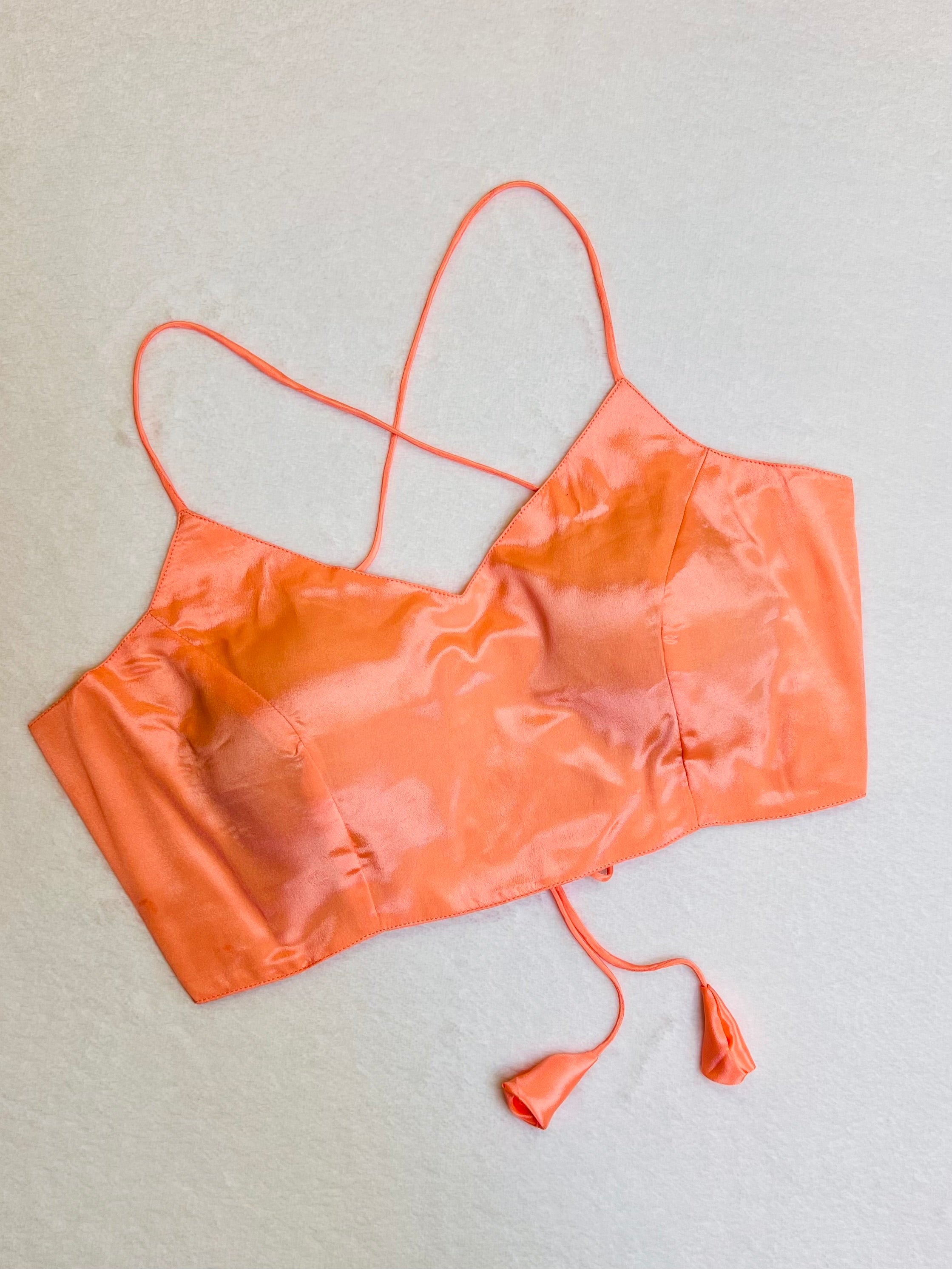 Peach satin sleeveless padded V-neck blouse, fully stitched women’s ethnic wear top on flat background