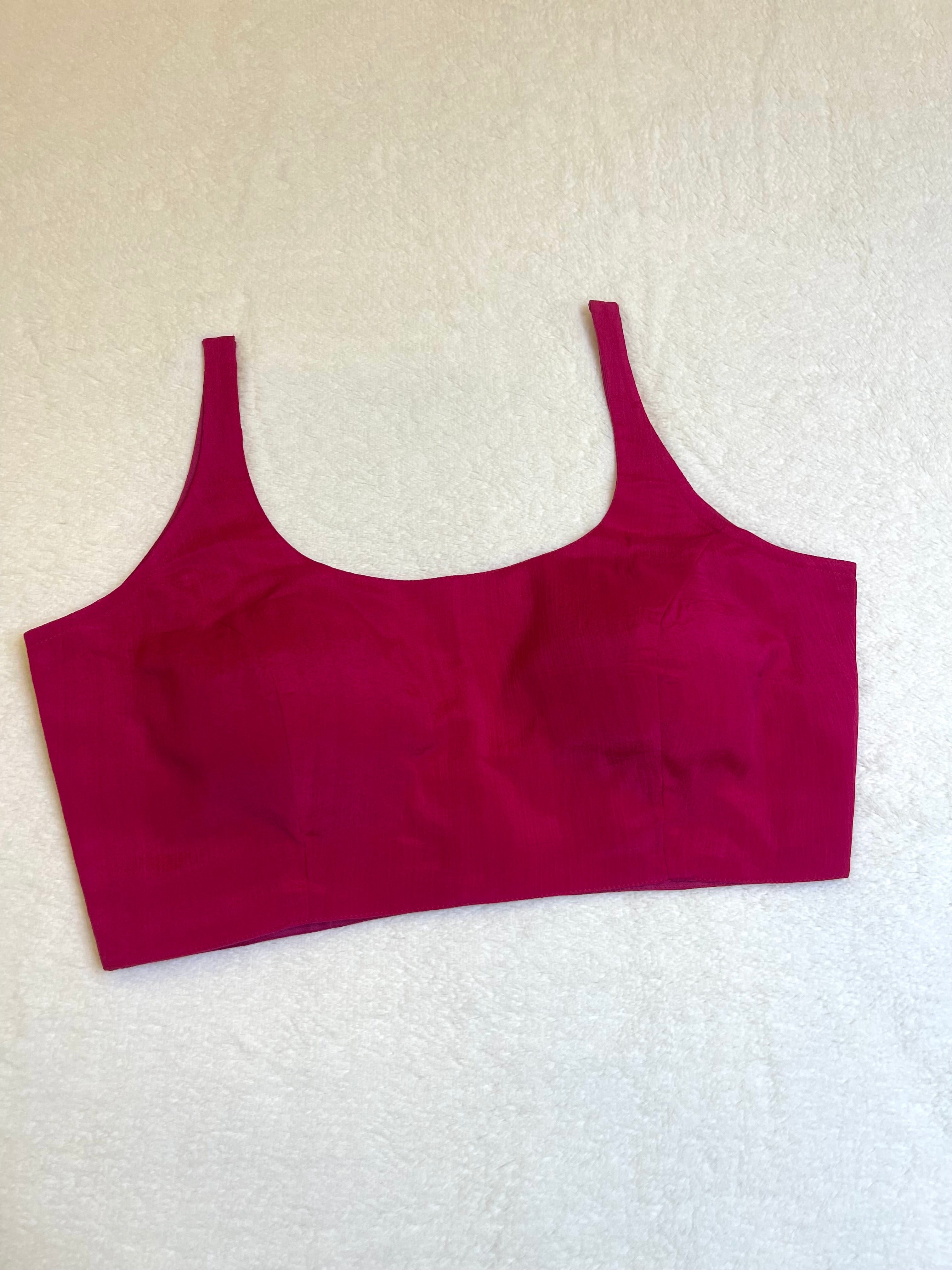 Rani pink chiffon sleeveless padded blouse with round neckline – fully stitched ethnic wear top on flat background