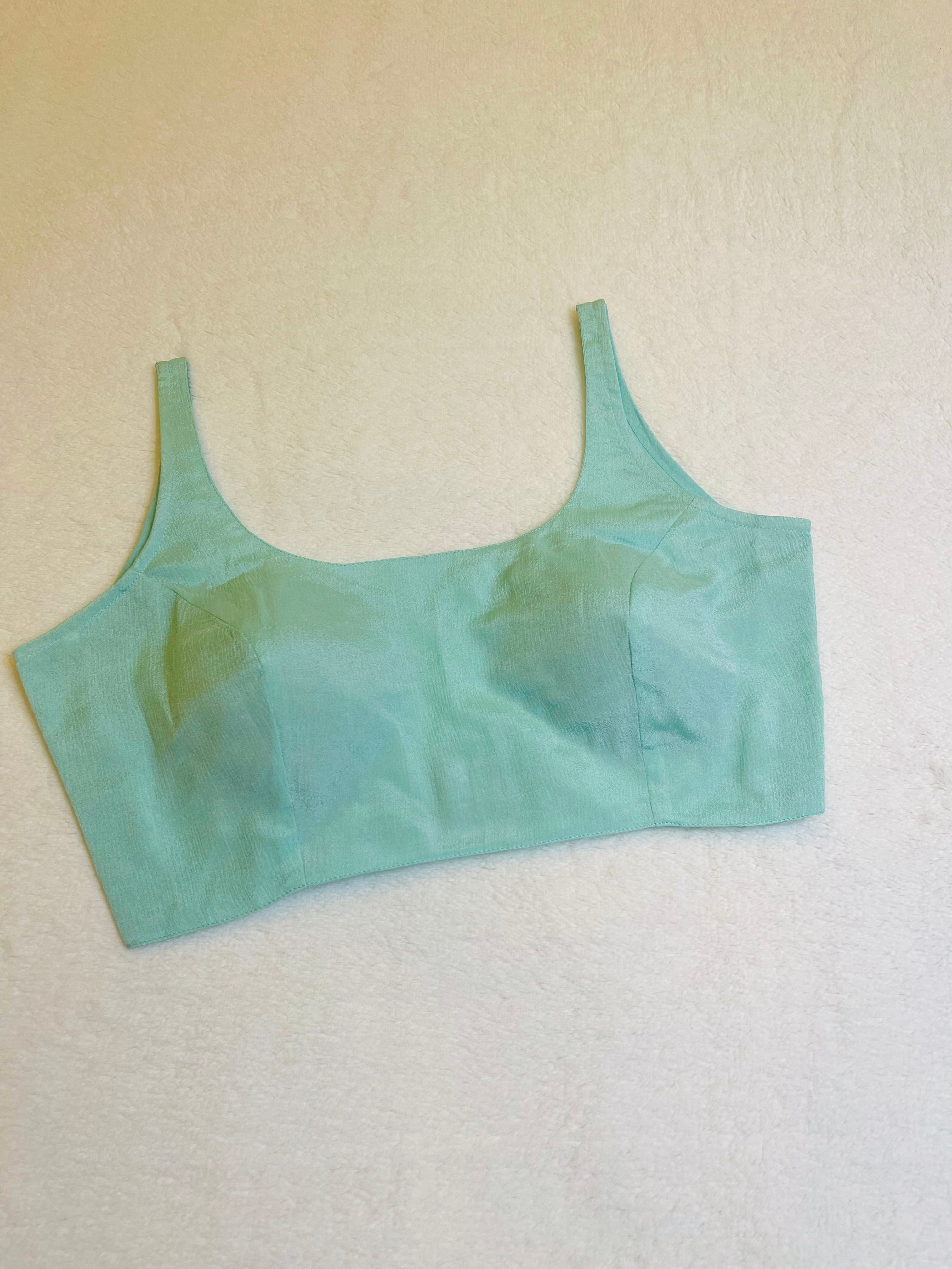 Sky blue chiffon sleeveless padded blouse with round neckline – fully stitched women’s ethnic top on flat background