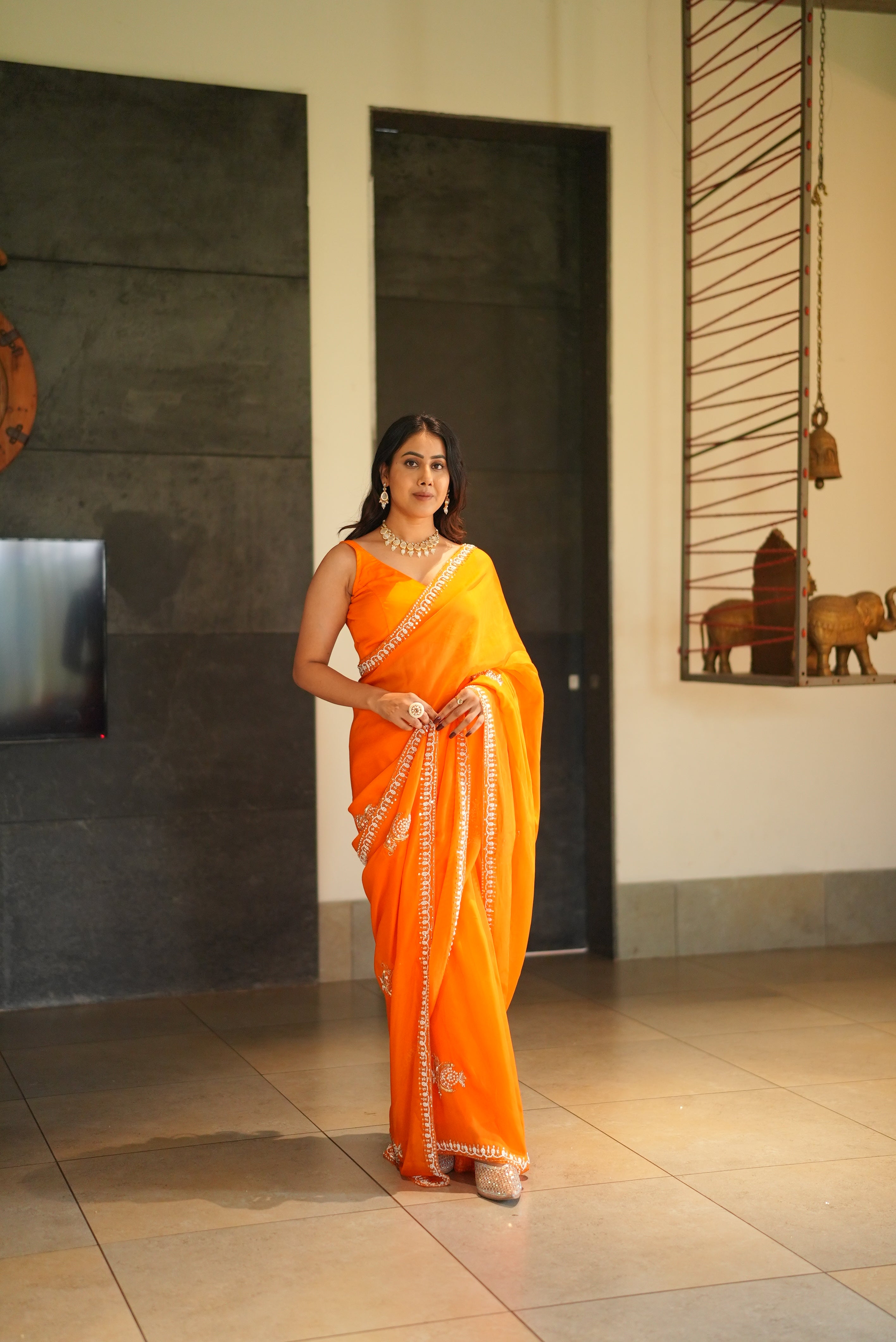 Organza saree featuring antique handwork detailing