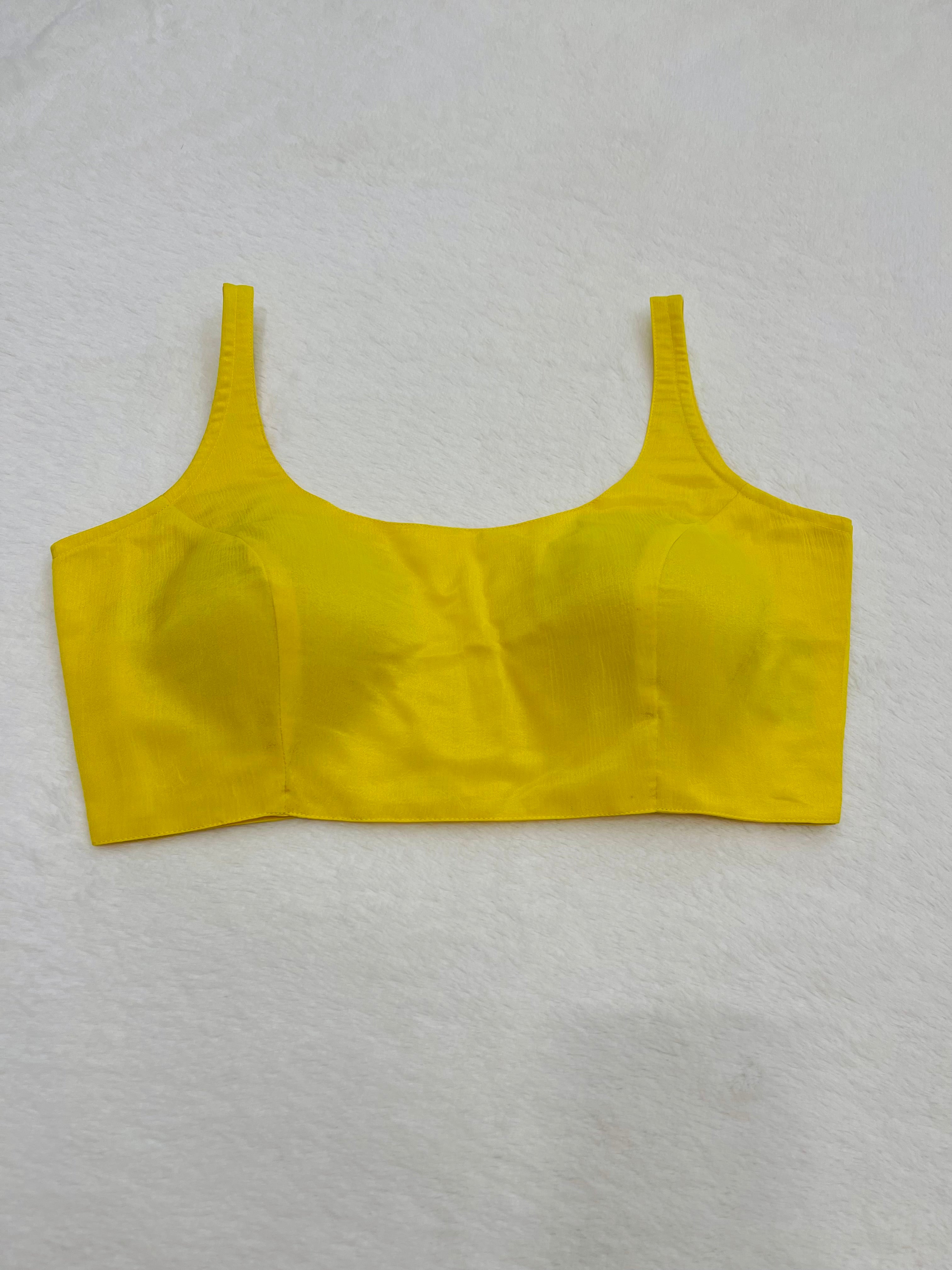 Yellow chiffon sleeveless padded blouse with round neckline – fully stitched women’s ethnic top on flat background